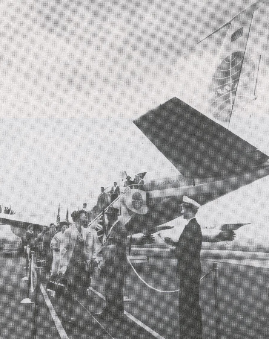 1959 Customers deplane the rear door of a Pan Am  707 onto a painted ramp walkway.